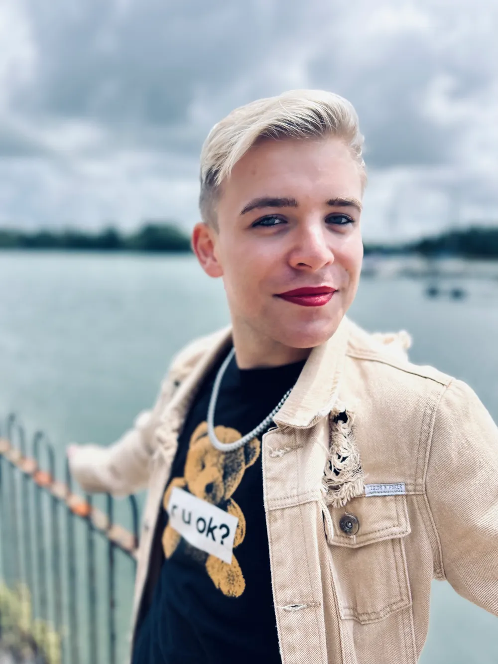 Ollie by the water in a cream denim jacket