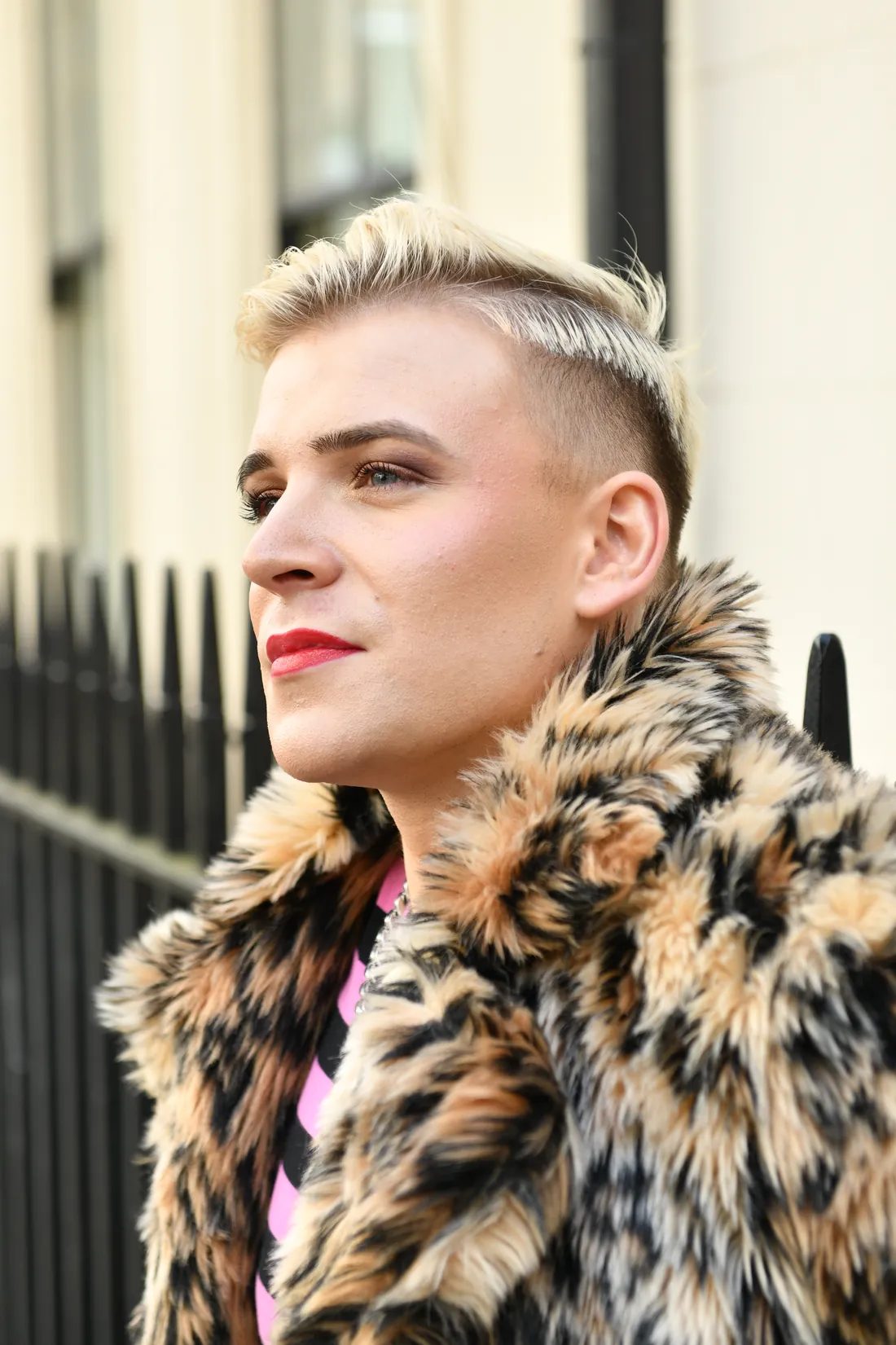 Ollie in a leopard print coat on a city street